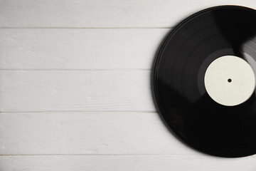 Vintage vinyl record on white wooden table, top view. Space for text