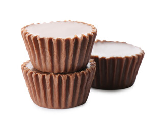 Delicious peanut butter cups on white background