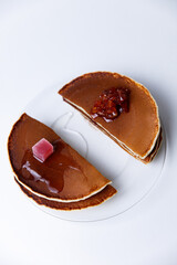 Stack of Tasty pancakes on white background