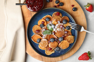 Cereal pancakes with berries on light grey marble table, flat lay