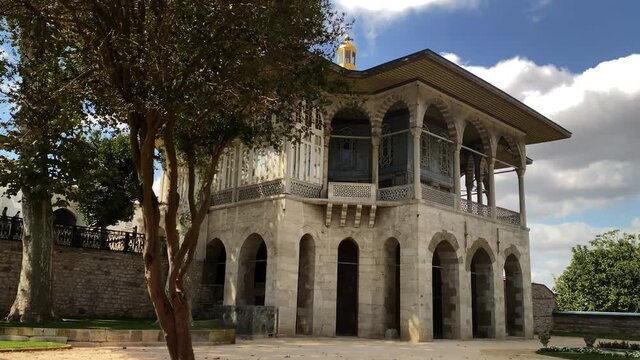 Tilt up from gardens to Agalar Mosque at Topkapi Palace in Istanbul 