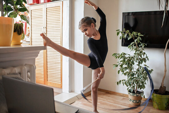 Pre Teen Girl In Black Sportswear Watching World Sport Competition Online And Repeating Exercises, Rhythmic Gymnastics, Sport And Health Concept, Social Distant Cheering