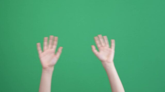 Kid hands waving saying greeting, goodbye making hand gestures on chroma key green screen background