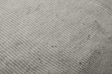 Fototapeta na wymiar Light cloth with bobbles, closeup. Before use of fabric shaver