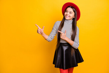 Portrait of pretty confident trendy cheerful long-haired girl demonstrating copy space solution isolated over bright yellow color background