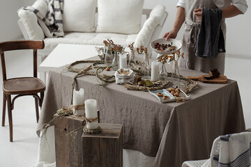 Process of decorating rustic style table with craft plates, linen tablecloth and napkins , gluten...