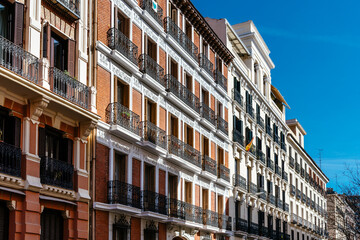 Fototapeta na wymiar Old luxury residential buildings with balconies in historic centre of Madrid. Concept rent regulation and real estate