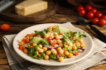 Delicious fresh chickpea salad on wooden table