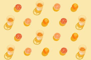 Creative pattern made with sliced grapefruit, blood orange and glass with lemonade or water on...