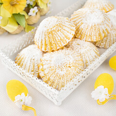 Small Easter shortbread muffins, filled with custard cream and sprinkled with powdered sugar.
