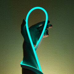 Flexible blue led tape neon in hand on black background