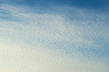 Sunset sky background. Picturesque colorful clouds lit by evening soft sunlight. Vast sky landscape scene - colorful sky