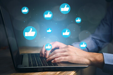 Hand of businessman using laptop with icon social media