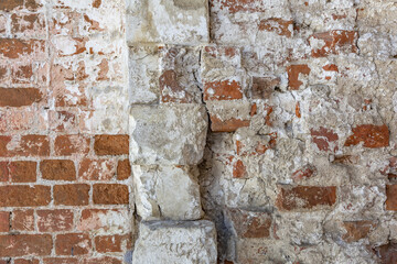 Embossed textured surface of an old wall made of facade bricks and cement