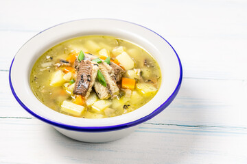 Traditional ukha, fish soup in a bowl on wooden background. Space for text.