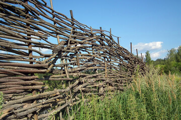 Fototapeta na wymiar Old wicker fence in a field