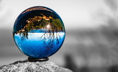Crystal ball alpine landscape shot with black and white background outside the sphere at the famous Kampenwand, Aschau im Chiemgau, Bavaria, Germany