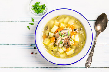  Instant pot fish and potato soup in a bowl on wooden background. Space for text, top view.