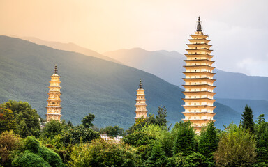 Beautiful scenic view of Dali Three Pagodas of Chongsheng Temple at sunset with dramatic light Dali Yunnan China