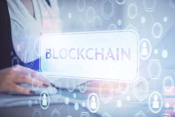 Double exposure of woman hands typing on computer and crypto market theme hologram drawing. Blockchain concept.