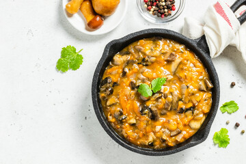 Vegan mushroom bourguignon in cast iron skillet. Space for text, top view.