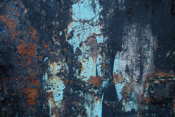 Rusty metal wall, the old sheet of iron covered with rust with blue and black paint.
