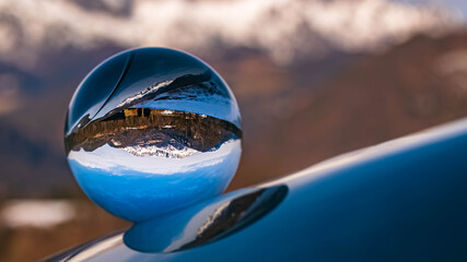 Crystal ball alpine landscape shot with black and white background outside the sphere at the famous Rossfeldstrasse near Berchtesgaden, Bavaria, Germany