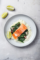 Salmon fillet with rice and spinach garnish
