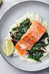 Salmon fillet with rice and spinach garnish