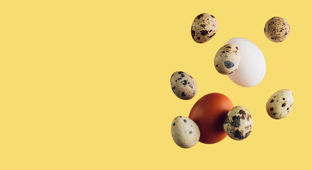 Falling chicken and quail eggs, isolated on yellow background,. Easter concept.