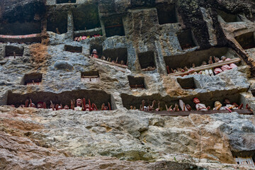 Rock tombs and galleries of Tau Tau in the steep rock face of the burial site of Lemo in Tana...