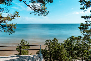 The Evazi bluff or steep by the Baltic Sea in Latvia during sunny summer day. Blue sky, blue sea,...
