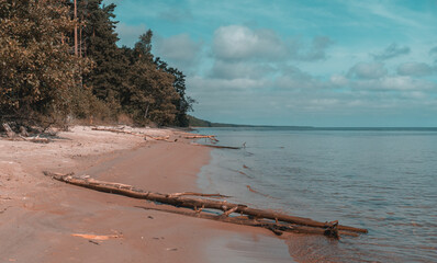 The Evazi bluff or steep by the Baltic Sea in Latvia during sunny summer day. Blue sky, blue sea, white sand.