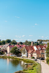 Old buildings by the Lake of Talsi in the old town of Talsi, Latvia during sunny summer day