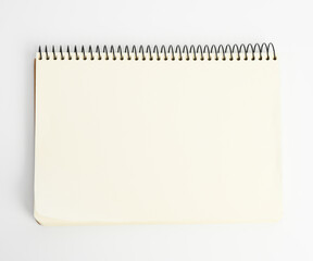 open spiral notepad with blank white sheets on white background