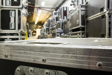Protective flight cases on wheels in warehouse storage zone. Backstage with empty flight cases from concert equipment.