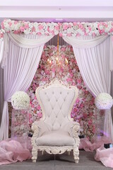 pink armchair in a room with curtains