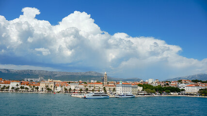 Fototapeta na wymiar Split City Harbor from upper deck of large sea ferry boat. Sea, passenger ship, city skyline with mountains.
