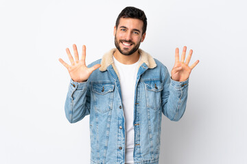 Young handsome man with beard isolated on white background counting nine with fingers