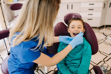 Girl at a dental clinic at a checkup. Patient at a dentist.