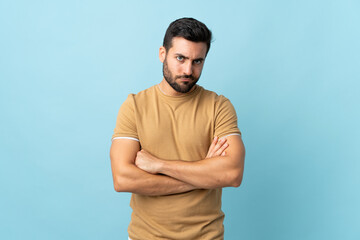 Fototapeta premium Young handsome man with beard over isolated background feeling upset