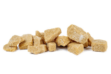 Pile of pieces of cane sugar isolated on white