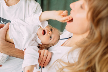 Parents have fun and play with their little son.