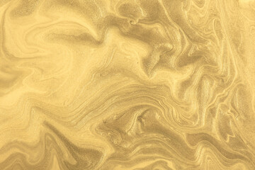 Abstract fluid art background dark golden colors. Liquid marble. Acrylic painting on canvas with yellow shiny gradient.