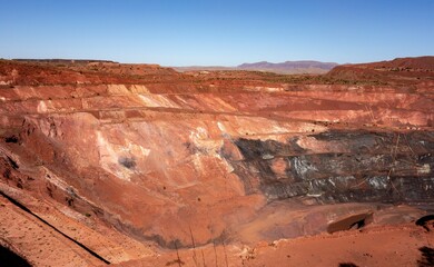 Deep pit of red iron ore mine in Pilbara region in Western Australia