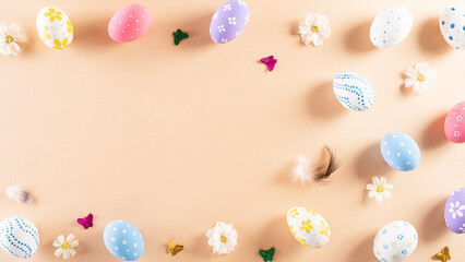 Obraz na płótnie Canvas Happy easter! Colourful of Easter eggs in with flower on pastel background. Greetings and presents for Easter Day celebrate time. Flat lay ,top view.