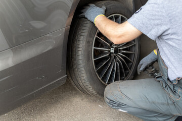 Car wheel repair shop outdoor ground . Seasonal winter tyre change at workshop. Vehicle tire...