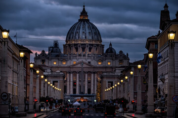 
Street with burning lanterns and St. Peter's Cathedral at night. Rome. Italy