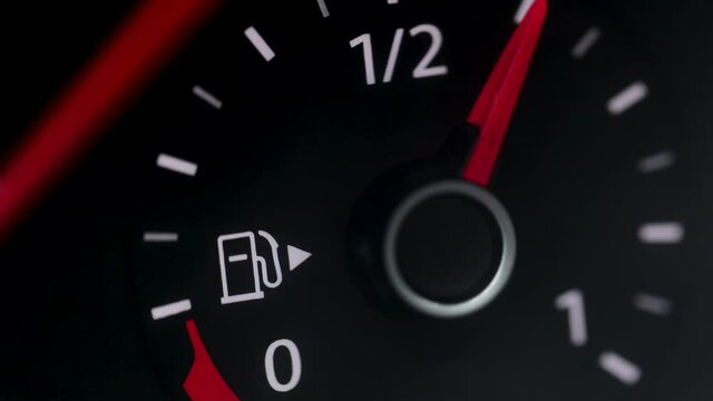 Fuel Gauge on Car Dashboard. Fuel Gauge and Indicator Lights of Starting and Stopping Car Close Up. Fuel Gauge White, Red empty-Full-empty Car Dashboard on Black background.