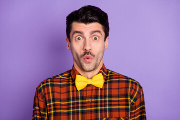 Photo of shocked amazed guy open mouth look camera wear bow tie plaid shirt isolated violet background